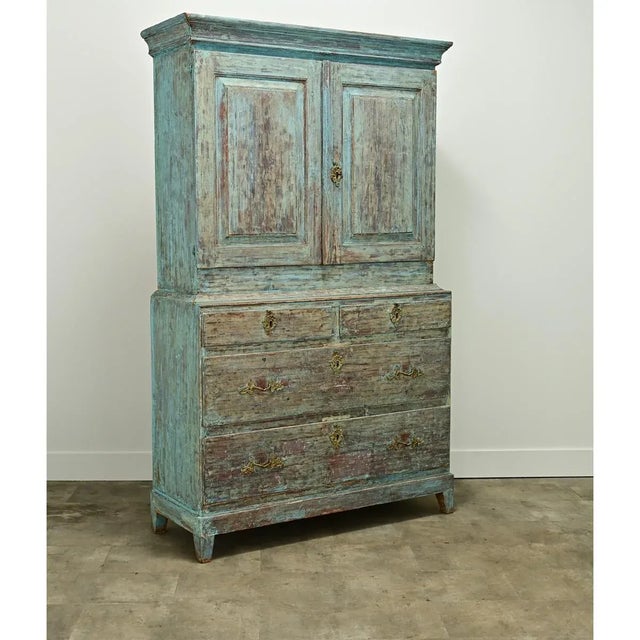Dimensions: 82 ¾” H x 49 ½” W x 18 ¾” D A Gustavian style painted cabinet made in Sweden circa 1860. This buffet over...