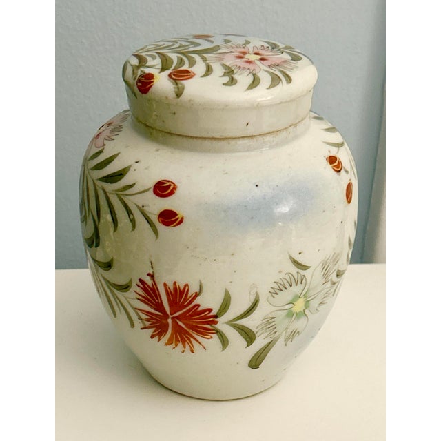 Charming mid‑century Chinese export hand‑painted lidded jar featuring soft pink, red, and green florals with delicate,...