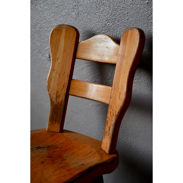 These cool brutalist bar stools are touching. In patinated solid wood and hammered wrought iron, they are simple and...