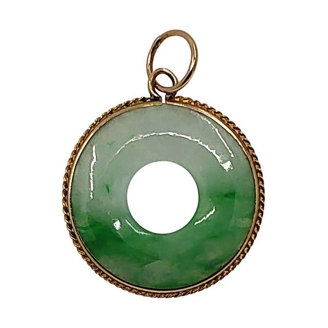 Estate Jade Pi Pendant. This estate jade pendant is a carved donut shape often referred to as a Pi pendant. The jade is a...