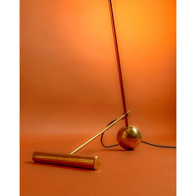Stilnovo design floor lamp, an original from the 1960s. Its base consists of a golden ball that supports the lamp's...