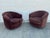 Pair of vintage barrel lounge chairs featuring rounded silhouettes, curved wraparound backs, channel-tufted detailing, and...
