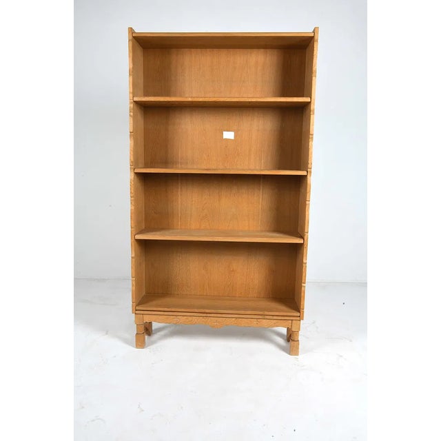 A substantial and architecturally grounded storage piece. Danish oak bookcase in the style of Henning Kjærnulf, dating to...