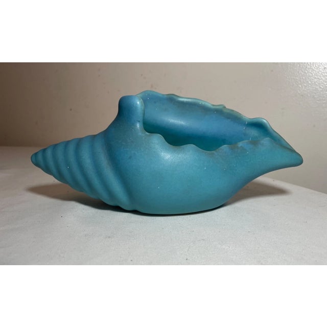 Up for sale is a rare antique original Van Briggle seashell pottery vase. It's done with a very vibrant blue colored...