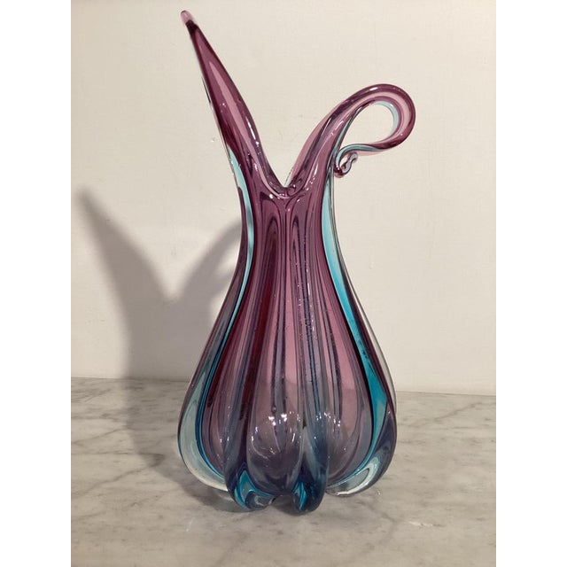Elegant Murano glass vase, crafted using the sommerso technique. It features a sophisticated layering of colors, blue...