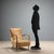 Armchair with exposed beech wood armrests, spring and foam padding, and vinyl upholstery. Fair condition, some signs of...
