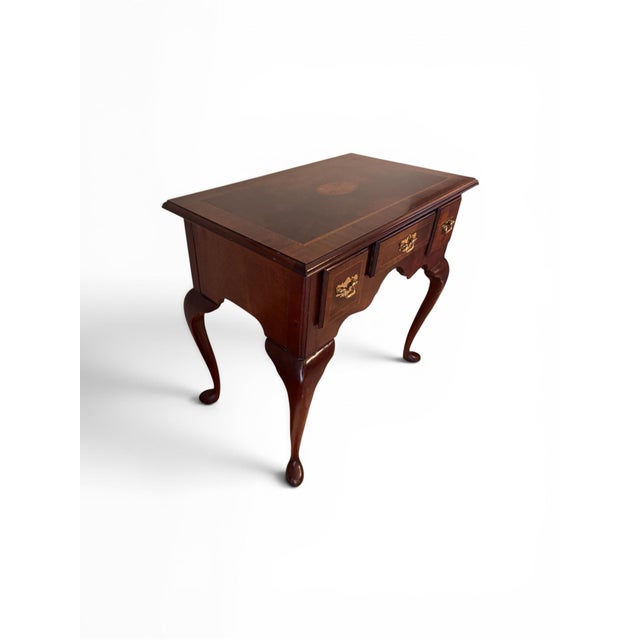 Queen Anne style inlaid mahogany lowboy table with three drawers featuring original brass hardware. 29.5” x 18” x 28”h...