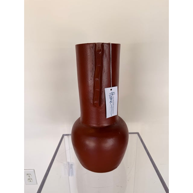 Contemporary decorative sculpture crafted from terracotta, featuring a rich earthy glazed finish and a bold, organic...