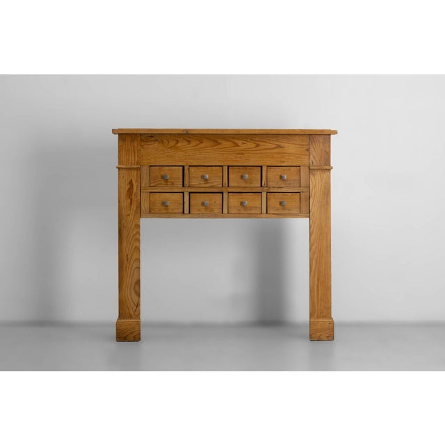Decorative pine mantelpiece with eight drawers France, circa 1920 A French pine mantelpiece dating from around 1920,...