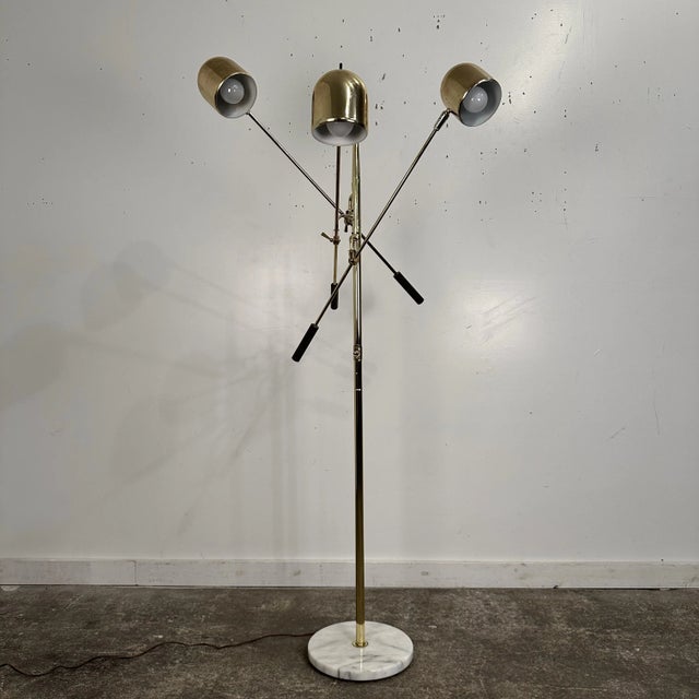 Mid-century modern triennale style brass coated floor lamp with marble base. No makers mark. In working order but we...