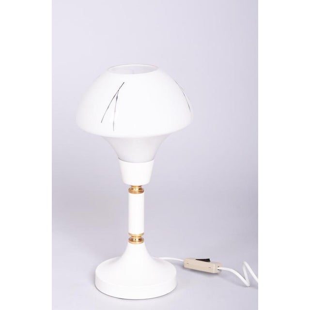 This elegant table lamp comes from 1960s Czechoslovakia and is a typical representative of "Mid-Century" era design. The...
