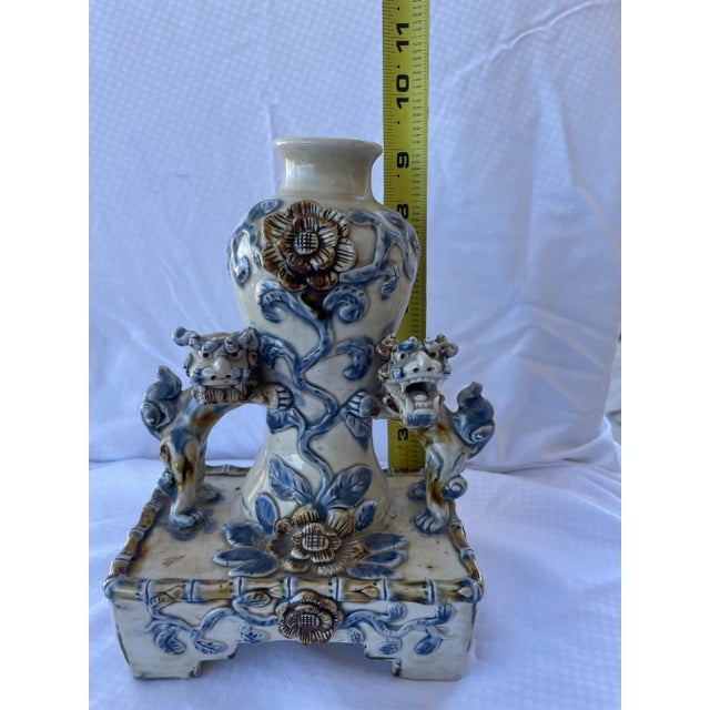 Great pair of handmade antique Chinese foo dogs happily posed guarding a vase, in classic blue and white. these were not...