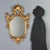 Carved and gilded wood mirror from late 19th century Italy. The design features a shaped central mirror framed by an...