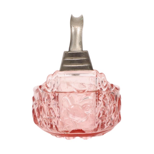 A vintage pink jardinière, planter, or bowl shaped like a basket with a handle; it features elegant high-relief motifs all...