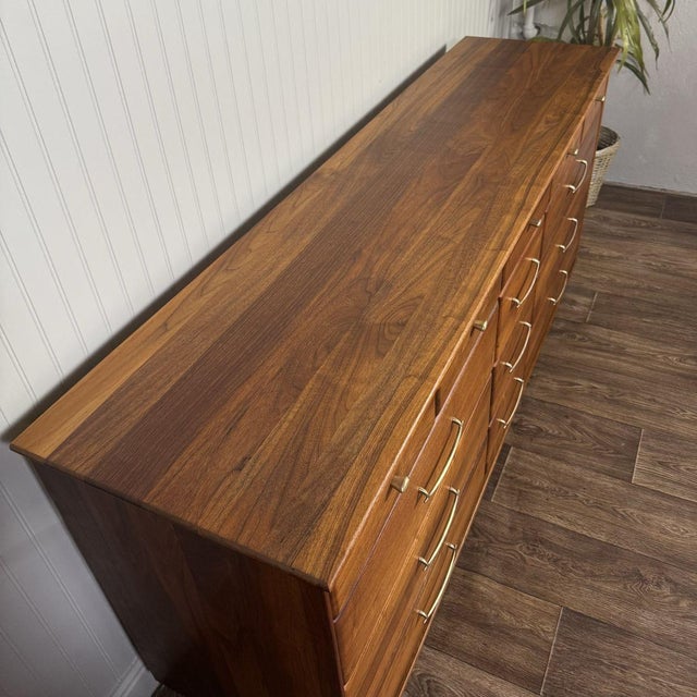Beautiful solid walnut mid-century modern dresser and matching nightstand, dated 1961. This set features gorgeous natural...