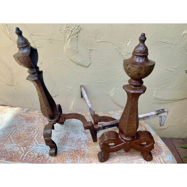 Antique art nouveau style bronze andirons. These andirons feature beautifully scrolled legs with a faceted center and...