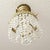 Crafted with an ornate brass frame, it features a decorative scrolled crown accent and detailed relief patterning along...