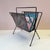 A stunning classic 1950/60’s black perforated metal magazine rack with black rod frame. Dimensions: 16.75”W x 10.25”D x 18”H