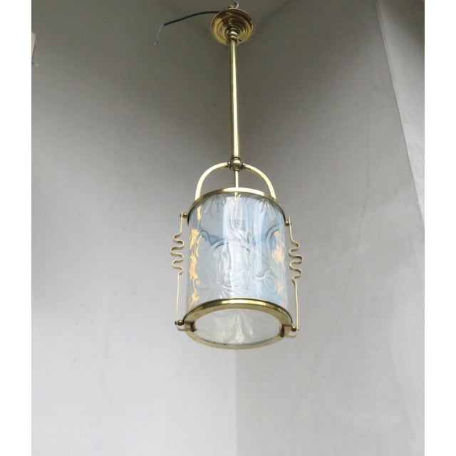 An exceptional ceiling lamp from the Art Nouveau period. The lampshade (tube) with a floral decoration is made of...