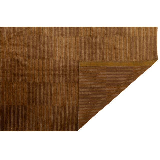 Handwoven in Nepal, this modern Tibetan rug blends wool and silk to create a rich, tactile surface with subtle luster. Its...