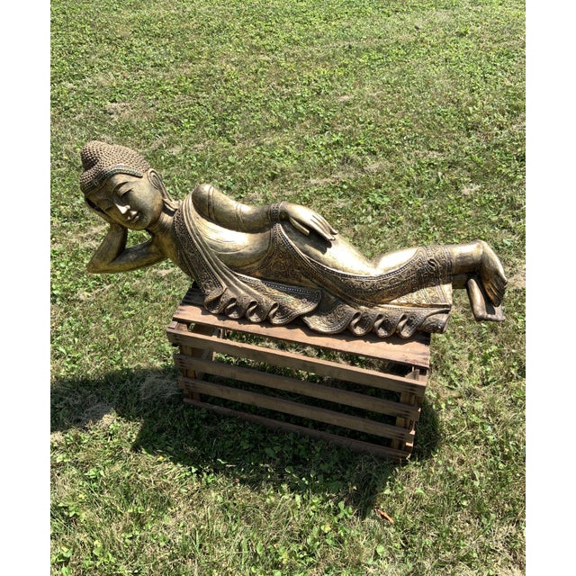 This Extra Large Gold Gilt Hand Carved Wooden Sleeping Buddha Statue is a stunning piece of art, measuring 40 inches long...