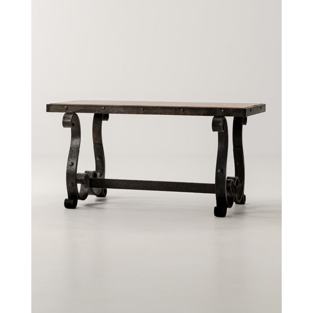 A masterwork of mid-century French craftsmanship, this circa 1940 wrought iron coffee table exemplifies the robust yet...