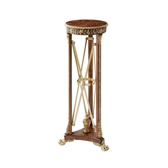 A fine pair of pedestals or carved and gilt torchères, the circular top with a carved edge and frieze, on three supports...