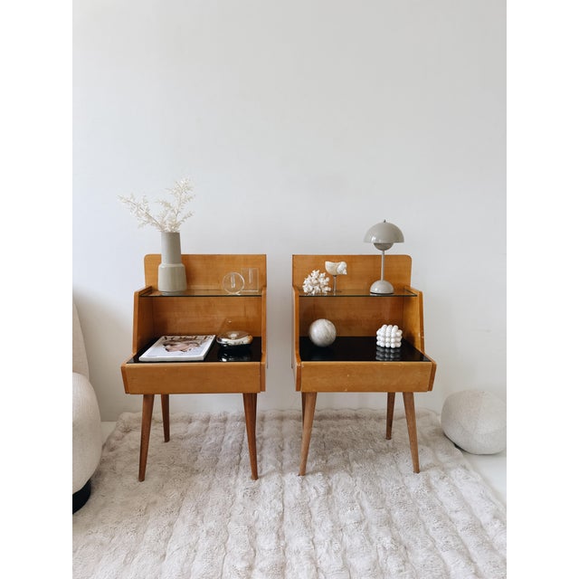 This elegant mid-century nightstand was designed and manufactured by Jitona Soběslav in former Czechoslovakia during the...