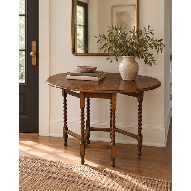 A very English solution to not having enough room. This vintage British oak gateleg table dates to approximately the 1920s...