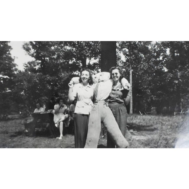 Mid 20th century snapshot photograph of party girls holding a strawman. Unframed, corner bumps.