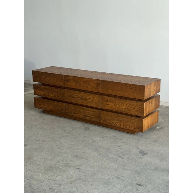 W82 D19 H29 This substantial 9 drawer dresser blends function with architectural design. Crafted from solid wood, this...