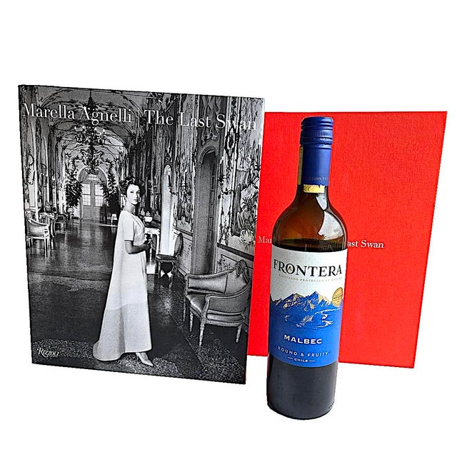 Offered is a coffee table book, "Marella Agnelli: The Last Swan", by Marella Agnelli and her niece Marella Caracciolo...