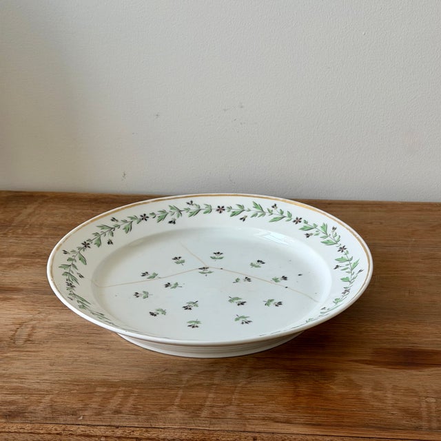 Antique early 19th century English porcelain serving dish with hand-painted floral sprigs, green garland border, and gilt...