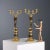 Pair of two-light candelabra in gilded and chiseled bronze. Leaf-shaped scroll arms resting on a fruit basket held by a...