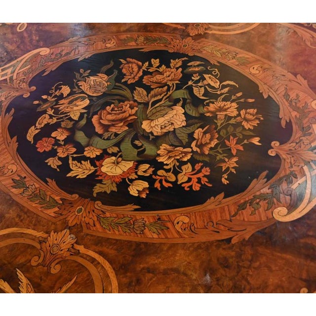 A superb french louis xv-style marquetry centre table of elegant serpentine form the shaped top is beautifully inlaid with...