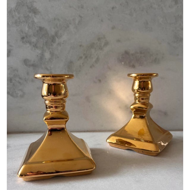 Set of 2 mid 20th century Royal Winton Grimwades porcelain candle holders with a square base and shiny gold finish. Made...