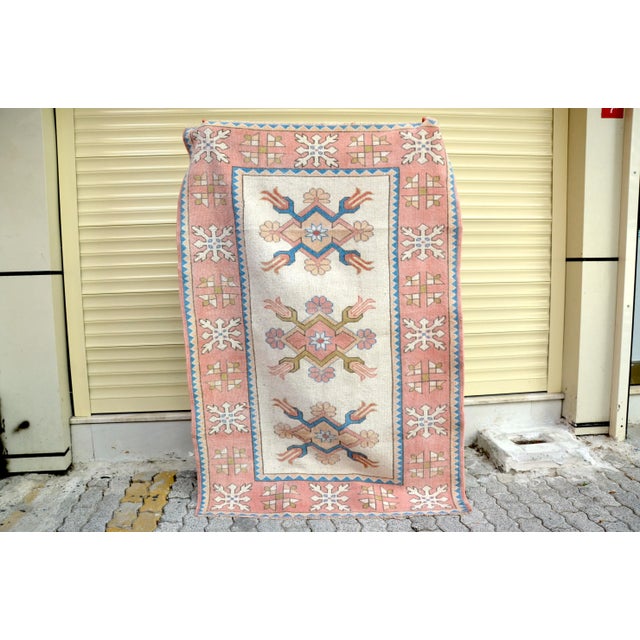 This is a vintage Turkish Oushak rug from the 1960s. The piece was hand-knotted.