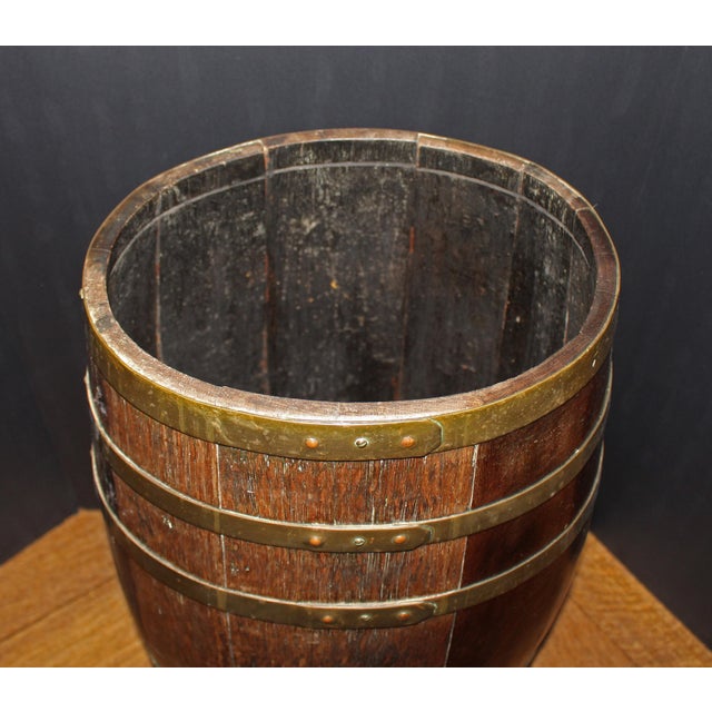 Later 19th century staved brass bound barrel stick stand, English. Oval. The brass straps have an Arts & Crafts motif....