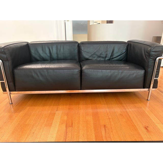 A rare opportunity to acquire a complete, authenticated Cassina LC3 Grand Confort suite — two two-seat sofas and two...