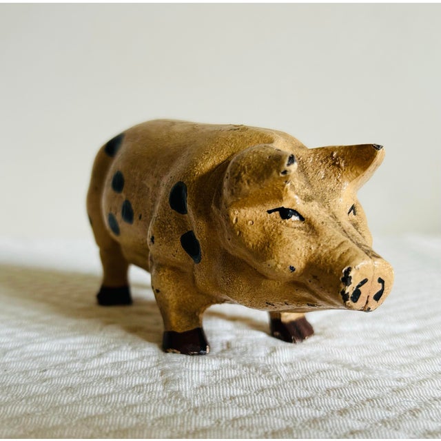 Antique hand painted cast iron pig figurine. Could be used as a paper weight or decor.