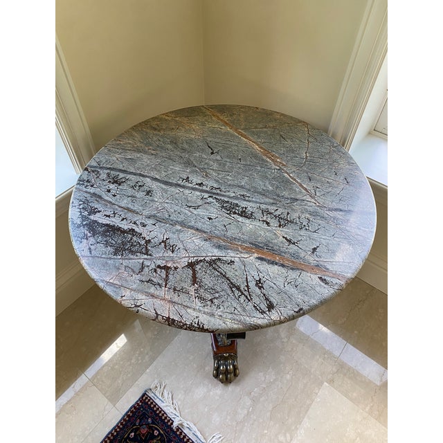 Elegant iron table with granite top. The year it was made is unknown. It was purchased in 2017.