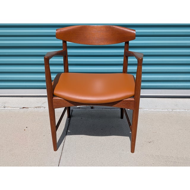 Authentic Ib Kofod-Larsen armchair for Selig, circa 1950s. Beautifully refinished teak frame paired with a rich cognac...