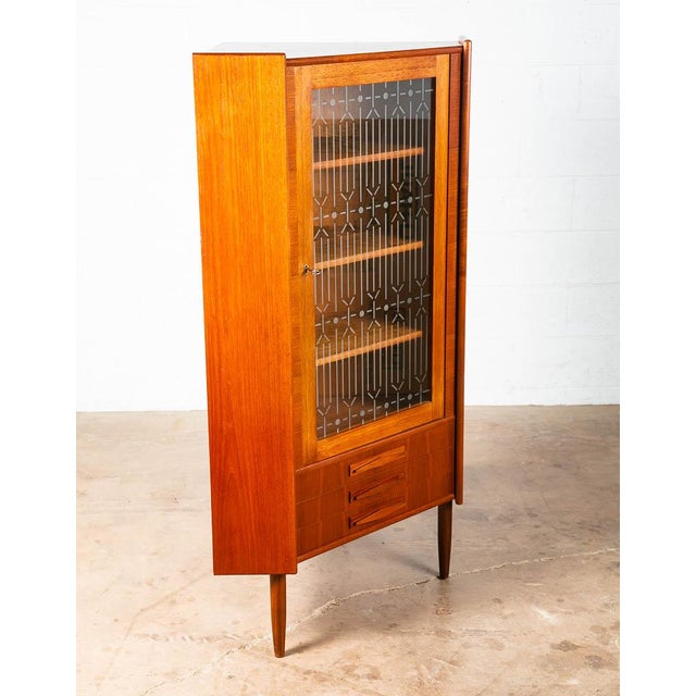 Outstanding Danish Teak corner cabinet designed in Denmark, circa 1960s. Features three drawers and an open storage space...