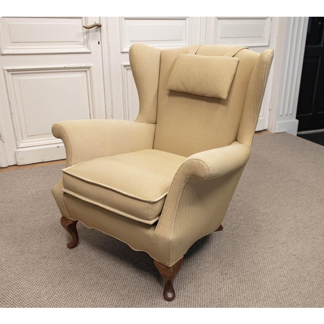 Elegant Danish wingback armchair designed by Ernst Kühn for Lysberg Hansen & Therp, Copenhagen, dating from the 1930s. The...