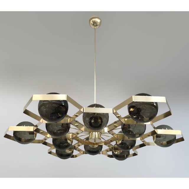 Italian modern chandelier with smoky Murano glass globes, mounted on solid brass frame in unlacquered natural brass finish...