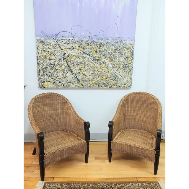 Here's a lovely pair of wicker lounge chairs circa 1980s. These feature mahogany arms and legs. The seat cushions are 100%...