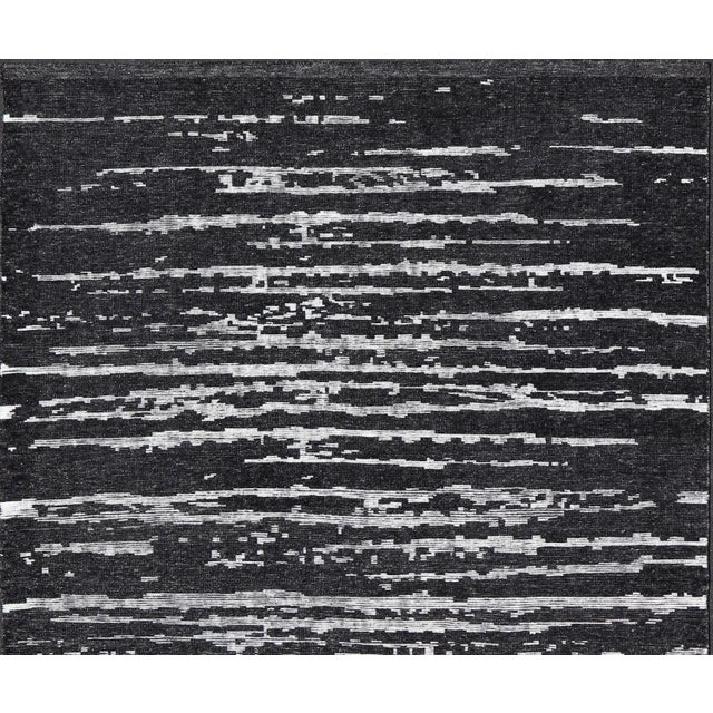 Measures 9'9 x 15'0 The field is an asymmetrical blend of black and white, creating an almost worn down look. The piece...