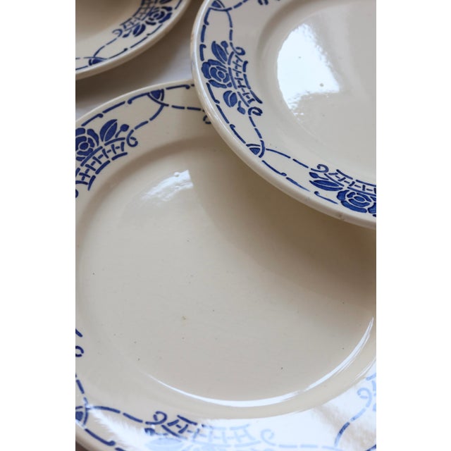 A beautiful set of six hbc choisy-le-roi earthenware dinner plates, in blue and white "georgette" pattern. A blue floral...