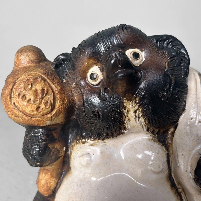 Cheerful Tanuki statue made of Shigaraki pottery, 1980s, Japan. Dimensions: height 26 cm, width 19 cm, depth 19 cm. This...
