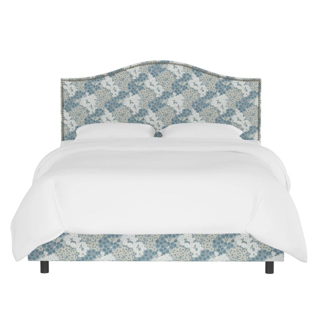 Give your interior a lift with the Bed. Featuring the delicate curves of a classic camelback design, with subtle nailhead...